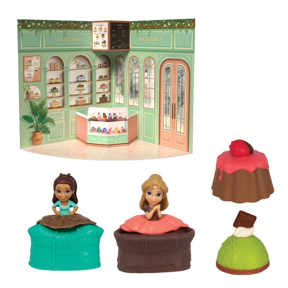 Toy set with dolls and cake figures in front of a toy bakery